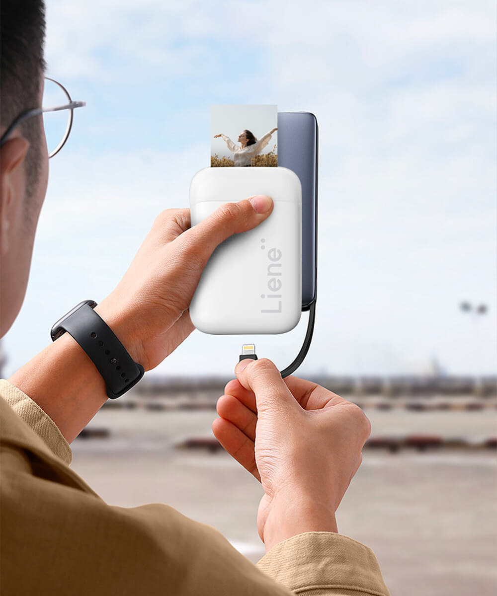The smartphone photo printer features a Type-C charging port and a long-lasting battery for up to 30 prints per charge.