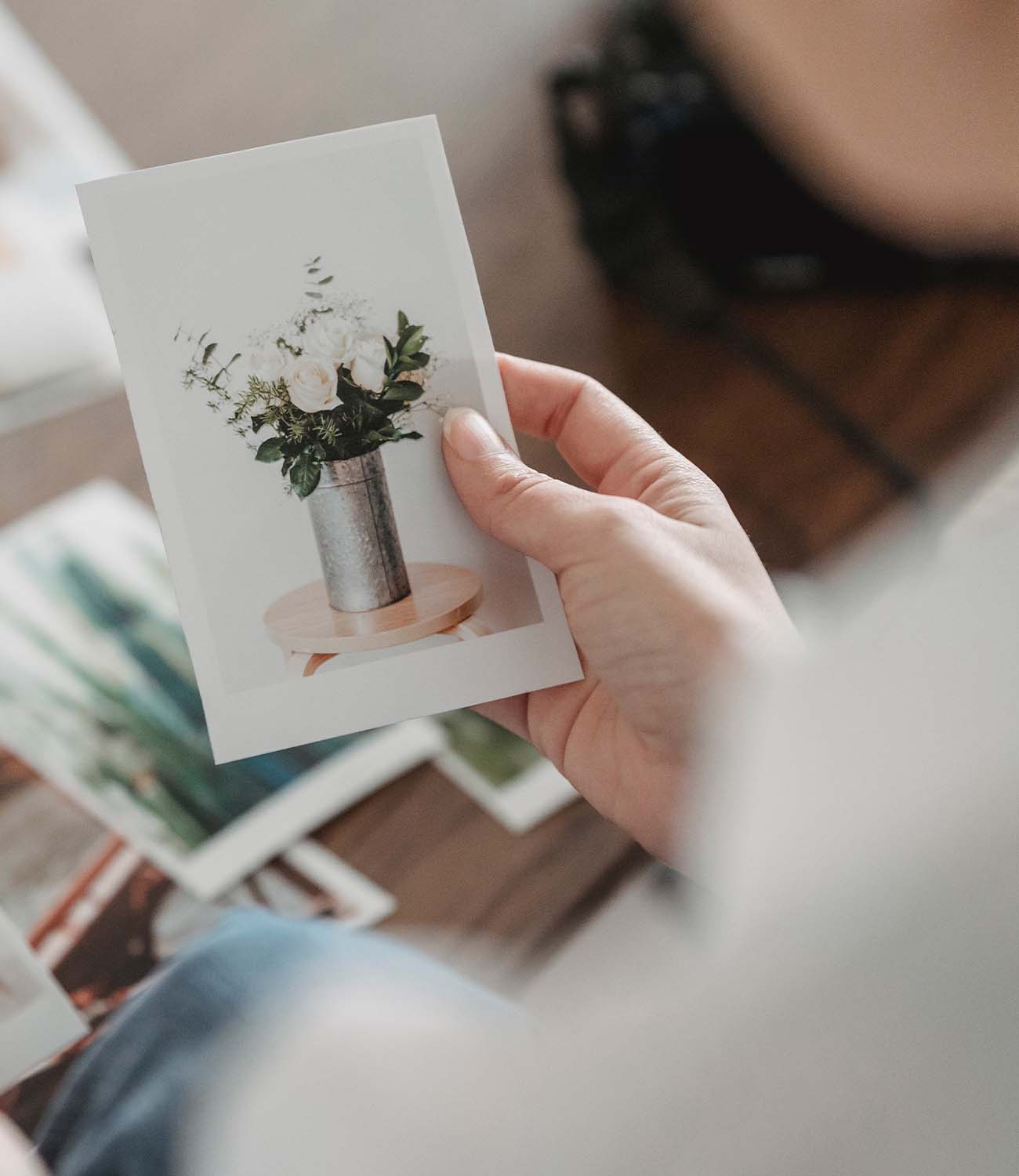 One hand holds a precious photo printed through liene photo printer