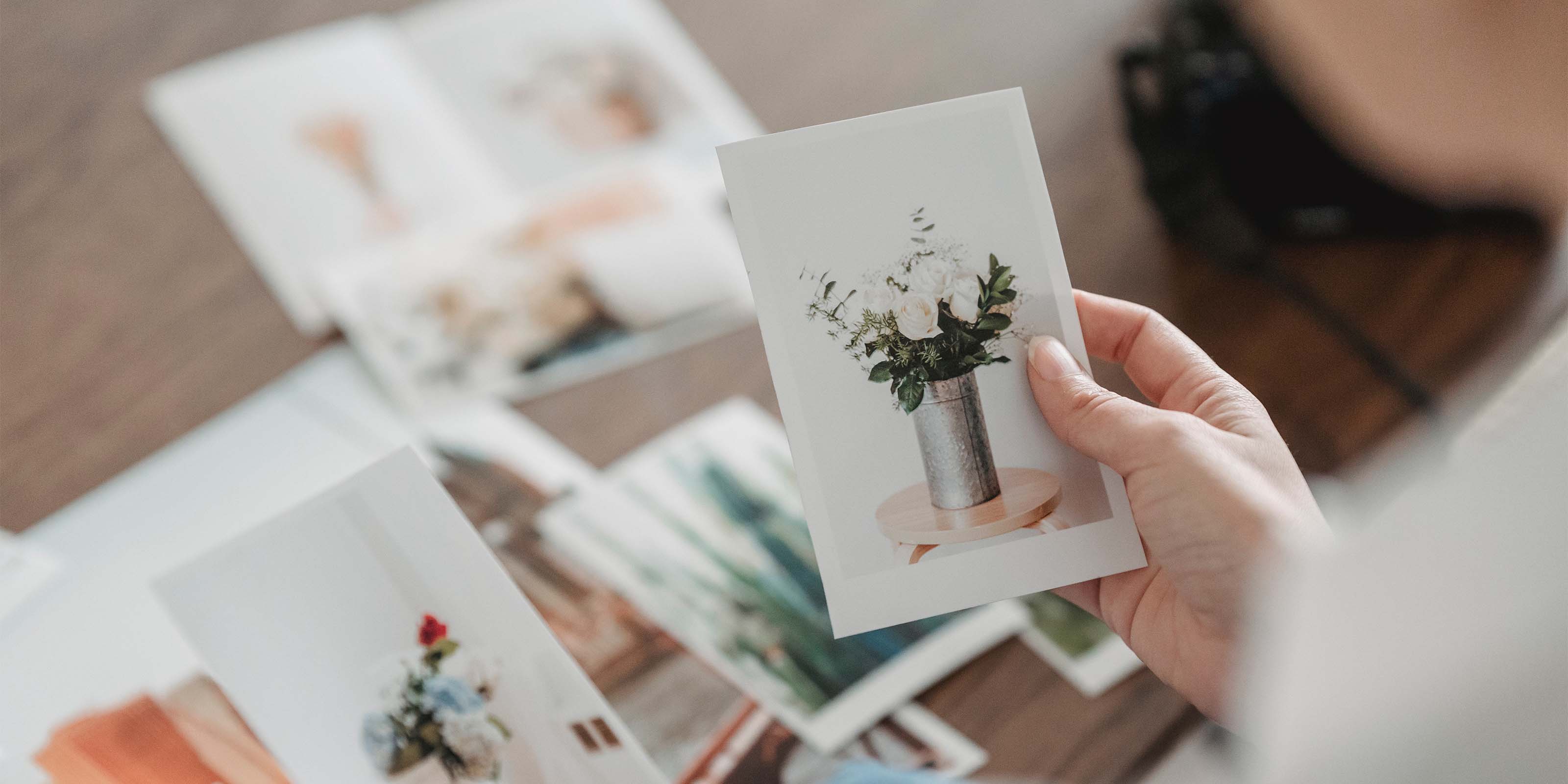 One hand holds a precious photo printed through liene photo printer