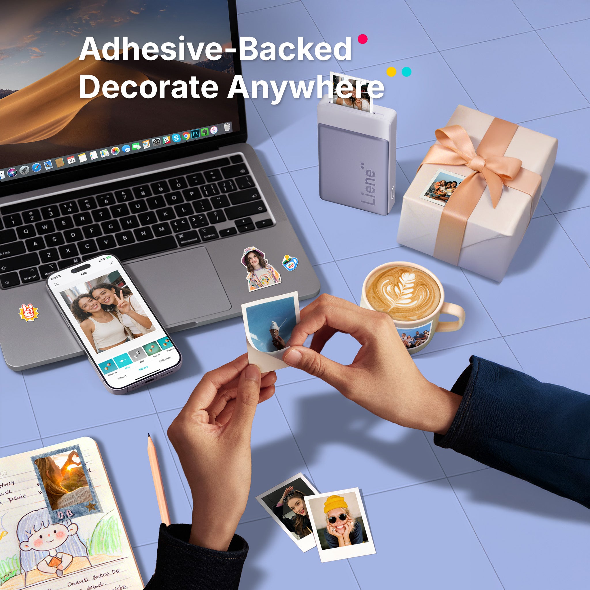 Laptop, phone, and coffee cup with adhesive-backed photos on a tiled floor background.